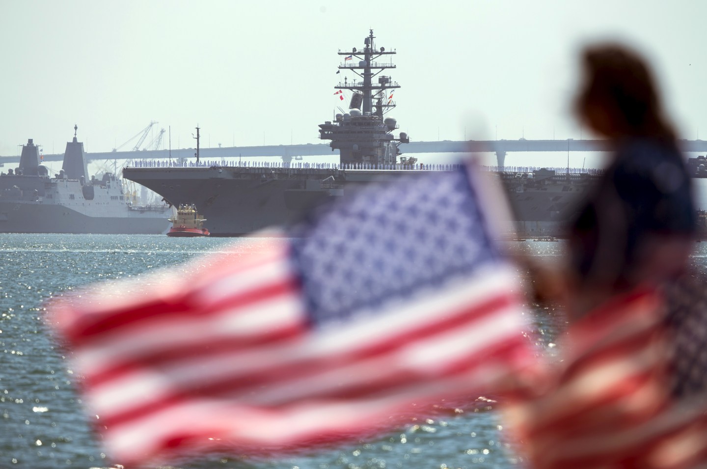 The USS Ronald Reagan is followed by USS Somerset as it departs for Yokosuka, Japan from Naval Station North Island in San Diego