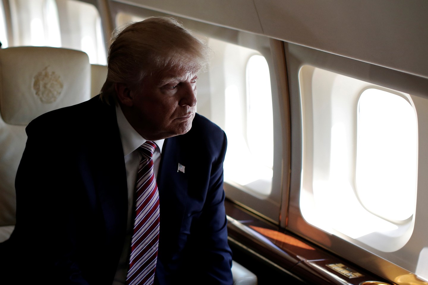Republican presidential nominee Donald Trump looks out the window as he travels aboard his plane between campaign stops in Ohio