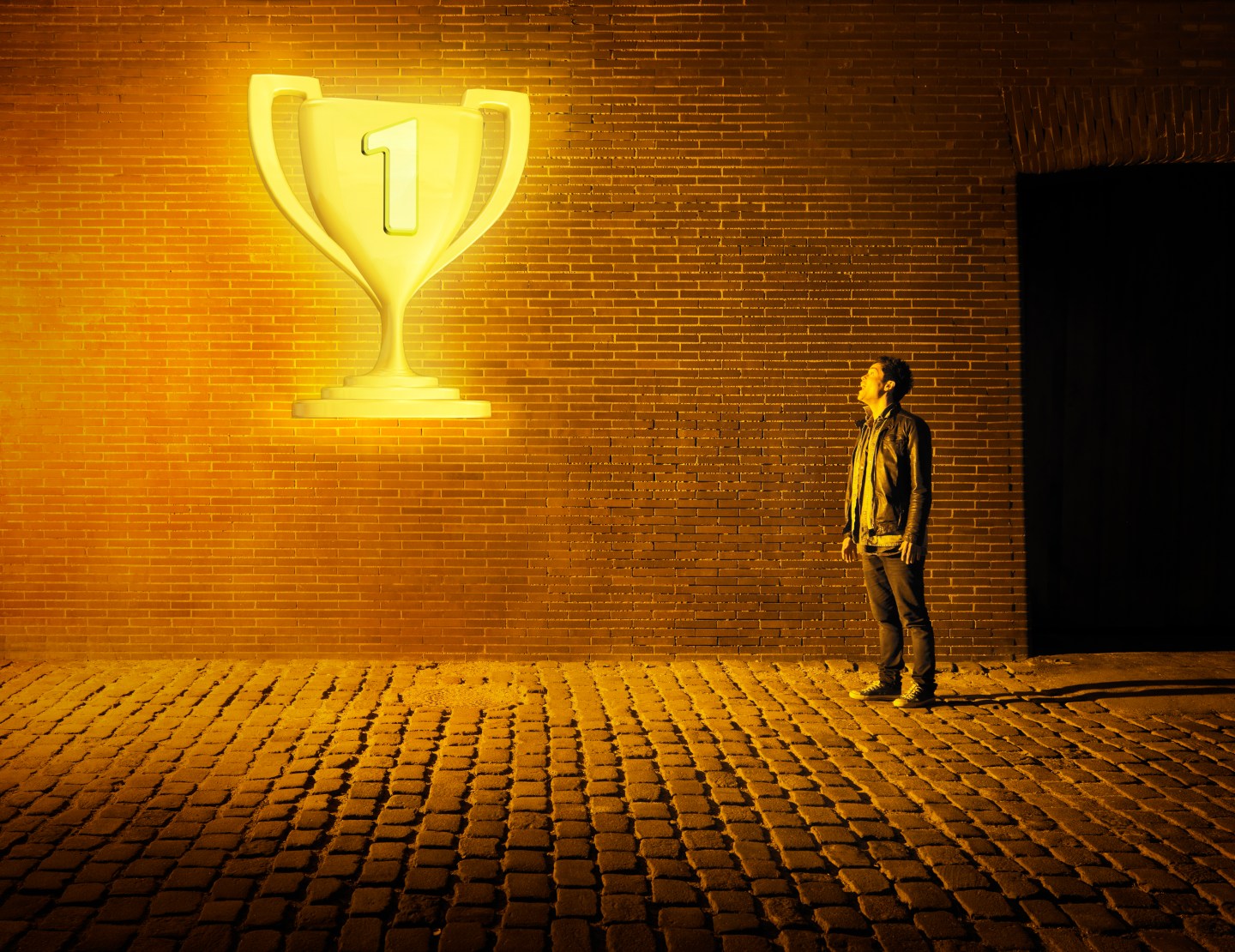 young man looking at glowing tropy