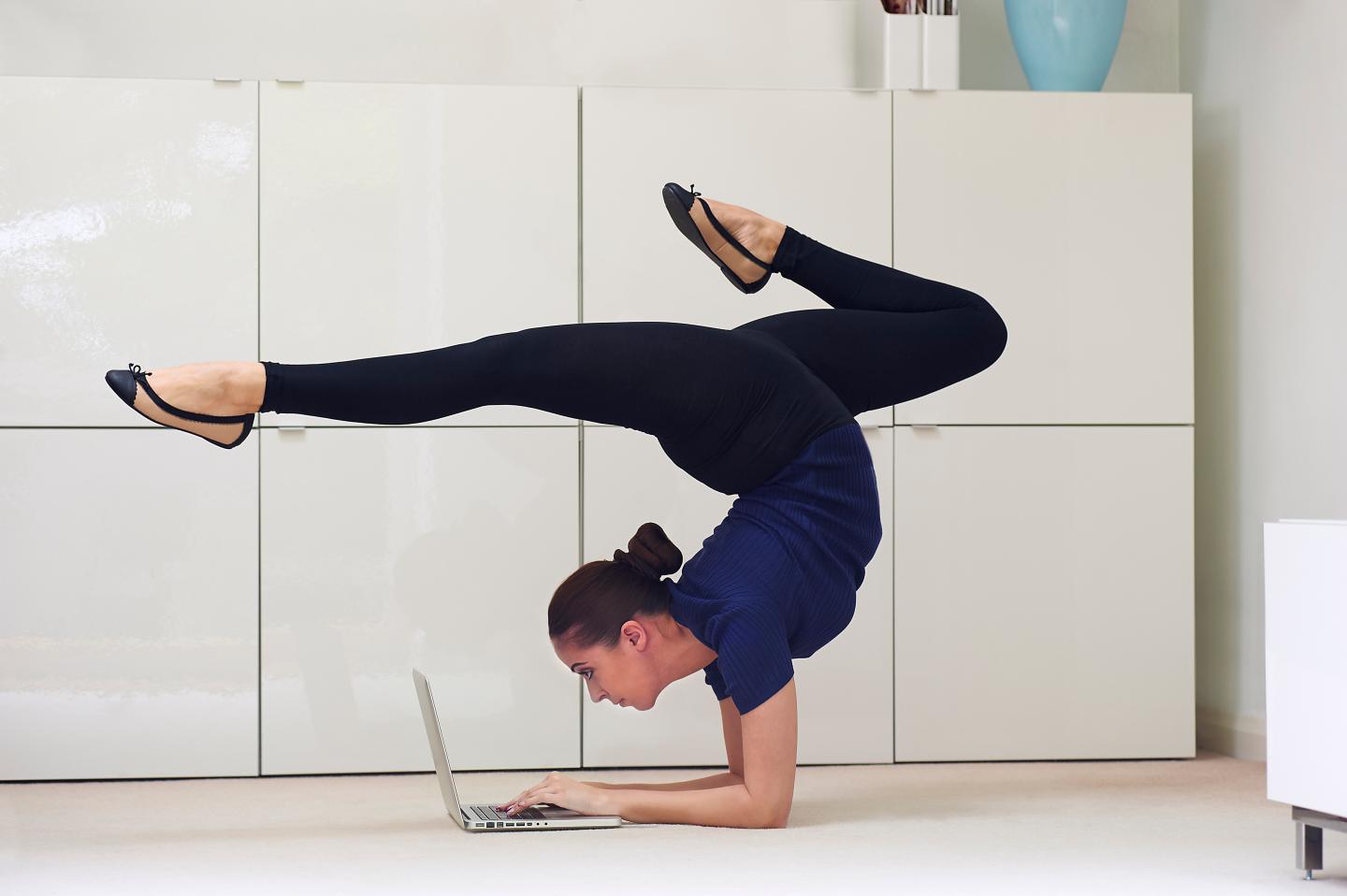 Contortionist using laptop computer