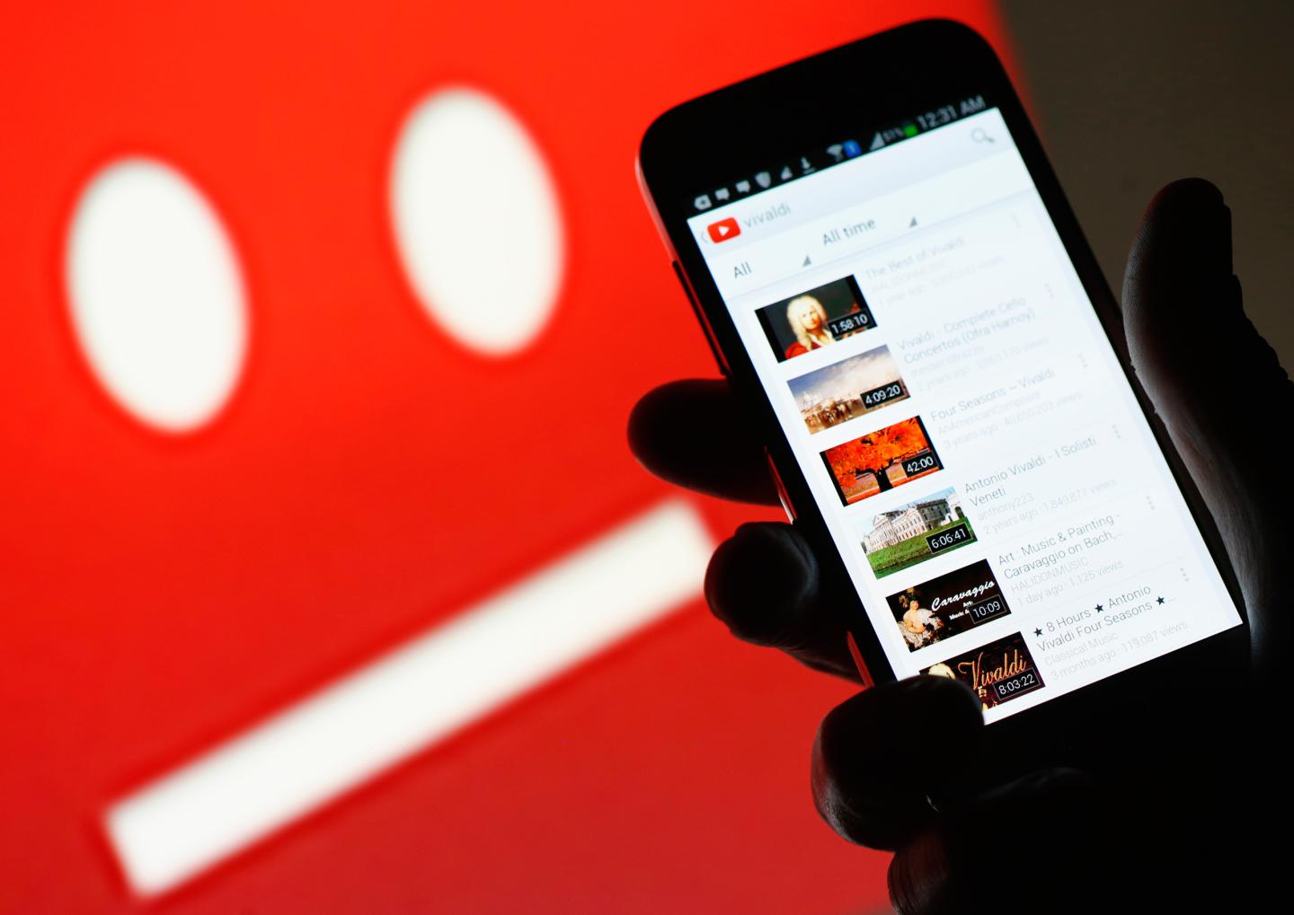 A picture illustration shows YouTube on a cell phone, in front of a YouTube copyright message regarding a video on an LCD screen, in central Bosnian town of Zenica