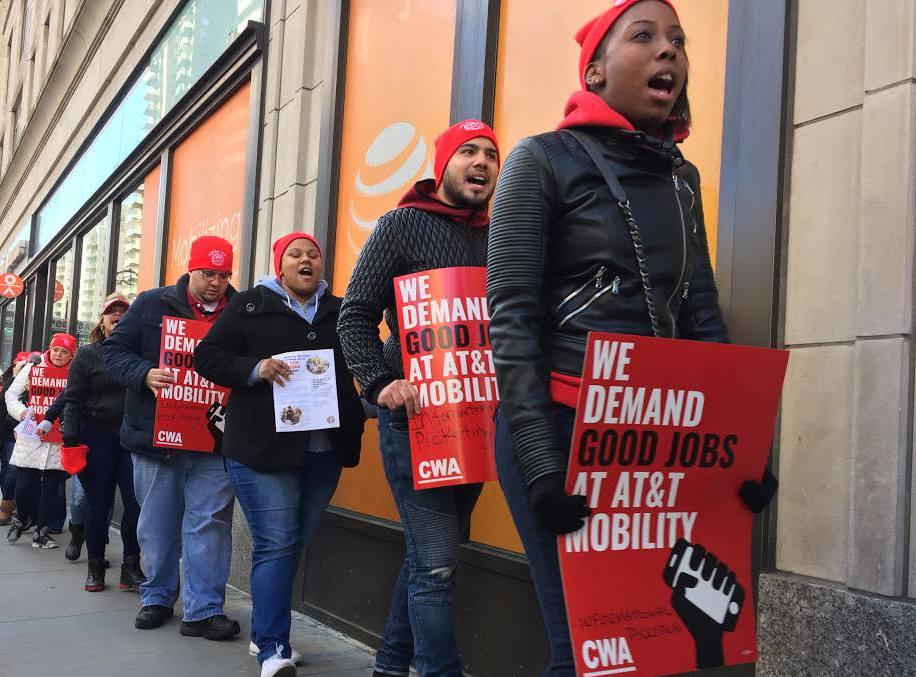 AT&T workers protest outside a store