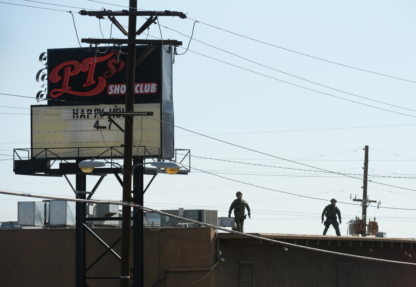Denver police clear the scene outside of PT's Showclub