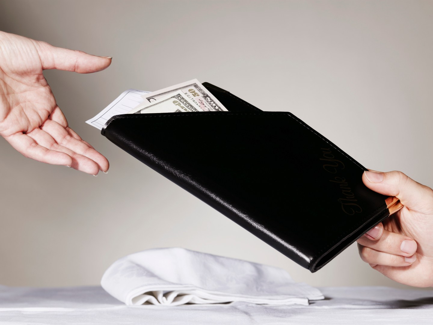 Person paying waiter for restaurant bill