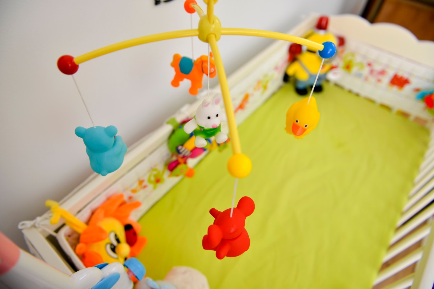 Baby cot with colorful toys hanging