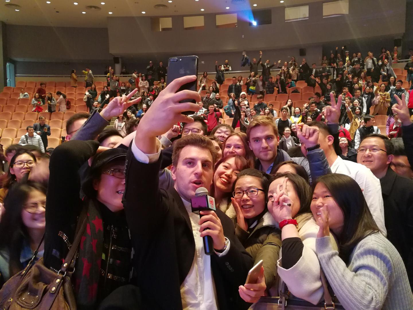 Airbnb Co-Founder and CEO Chesky pose for selfie with students at Fudan University in Shanghai