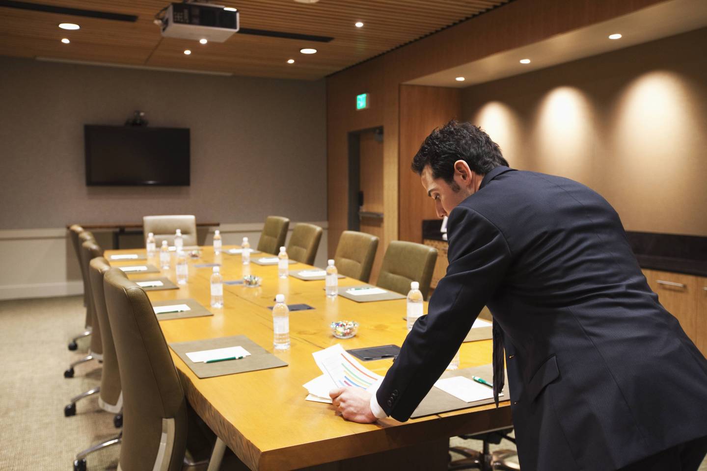 Caucasian businessman standing in empty conference room