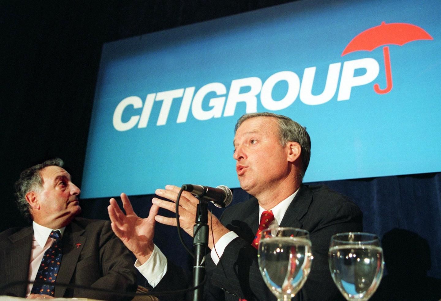 Sanford Weill (L), chairman and CEO of Travelers G