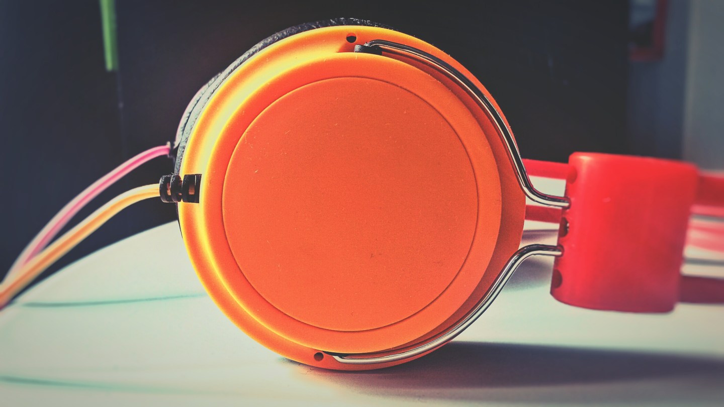 Close-Up Of Orange Headphones On Table At Home