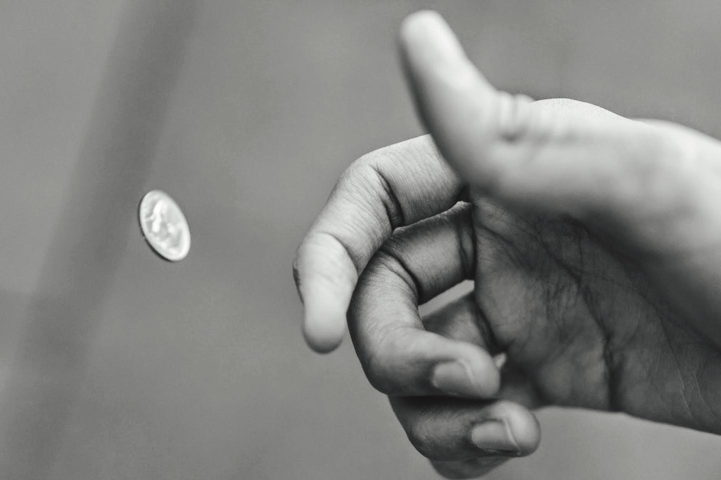 Man Flipping Coin