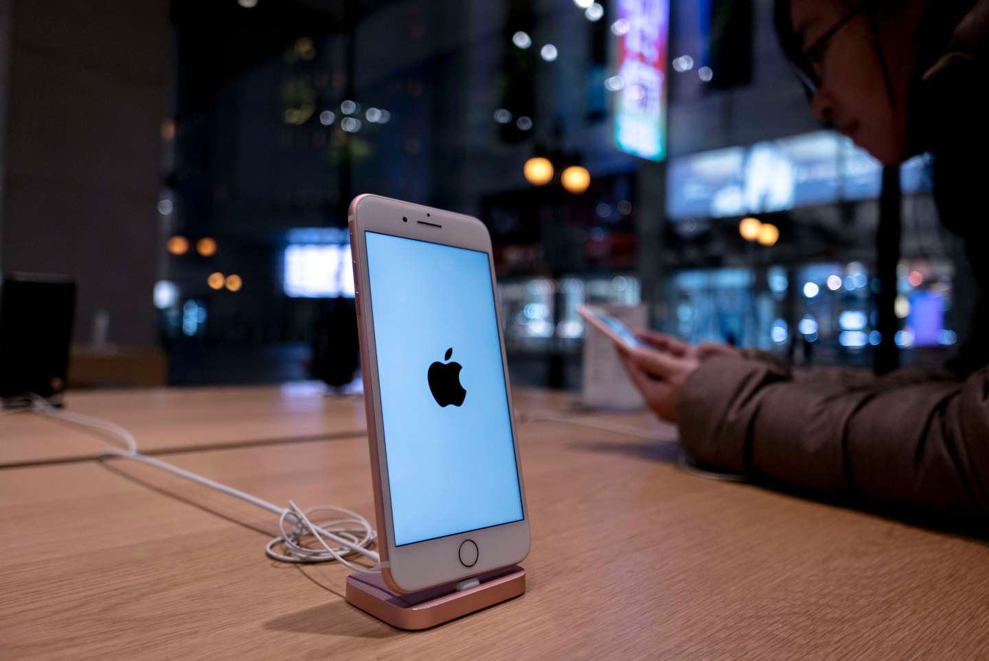 An iPhone 7 is exhibited in an Apple Store.  Because of the