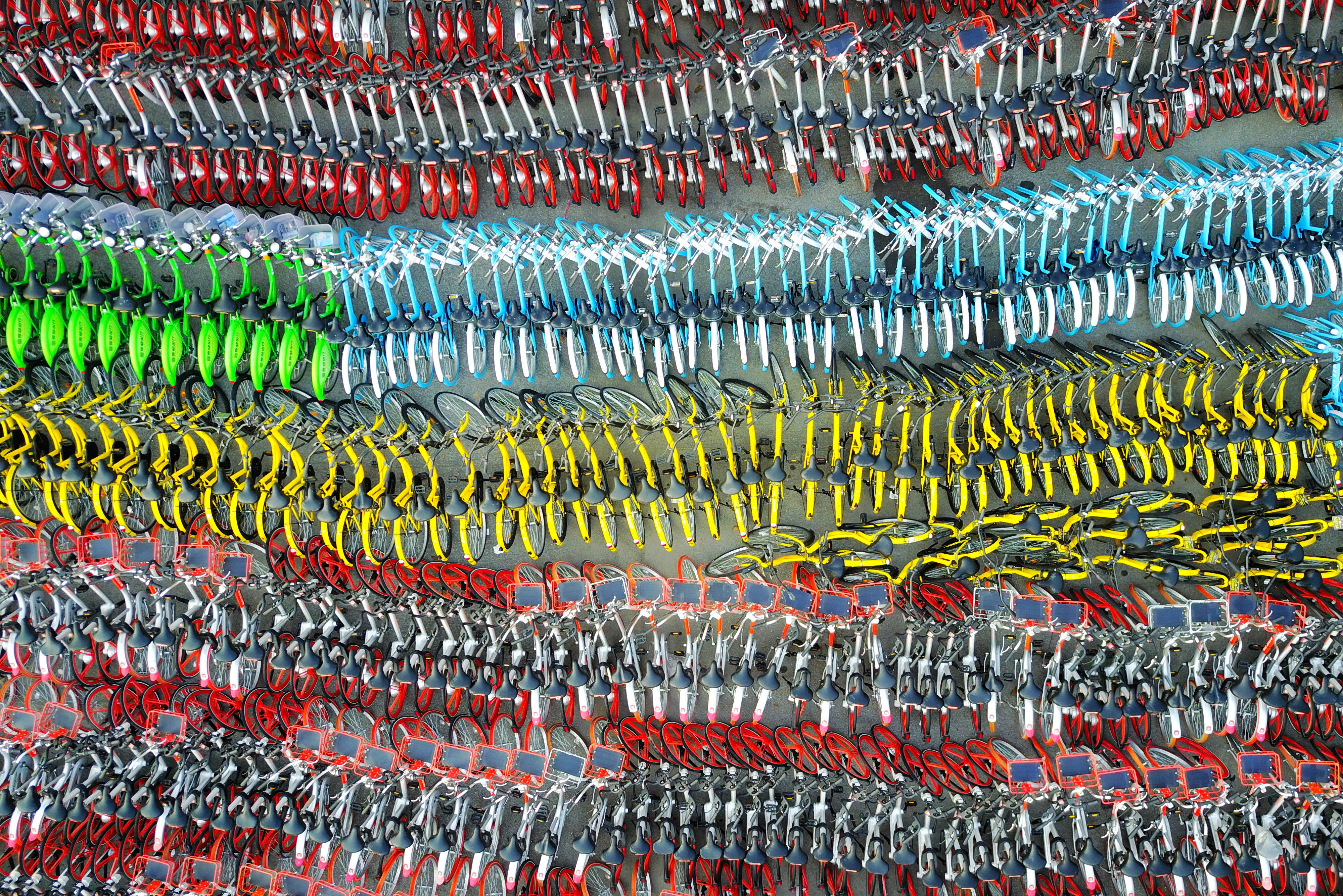 Confiscated sharing bicycles of different brands are seen at a parking lot of Huangpu District Vehicle Management Company in Shanghai