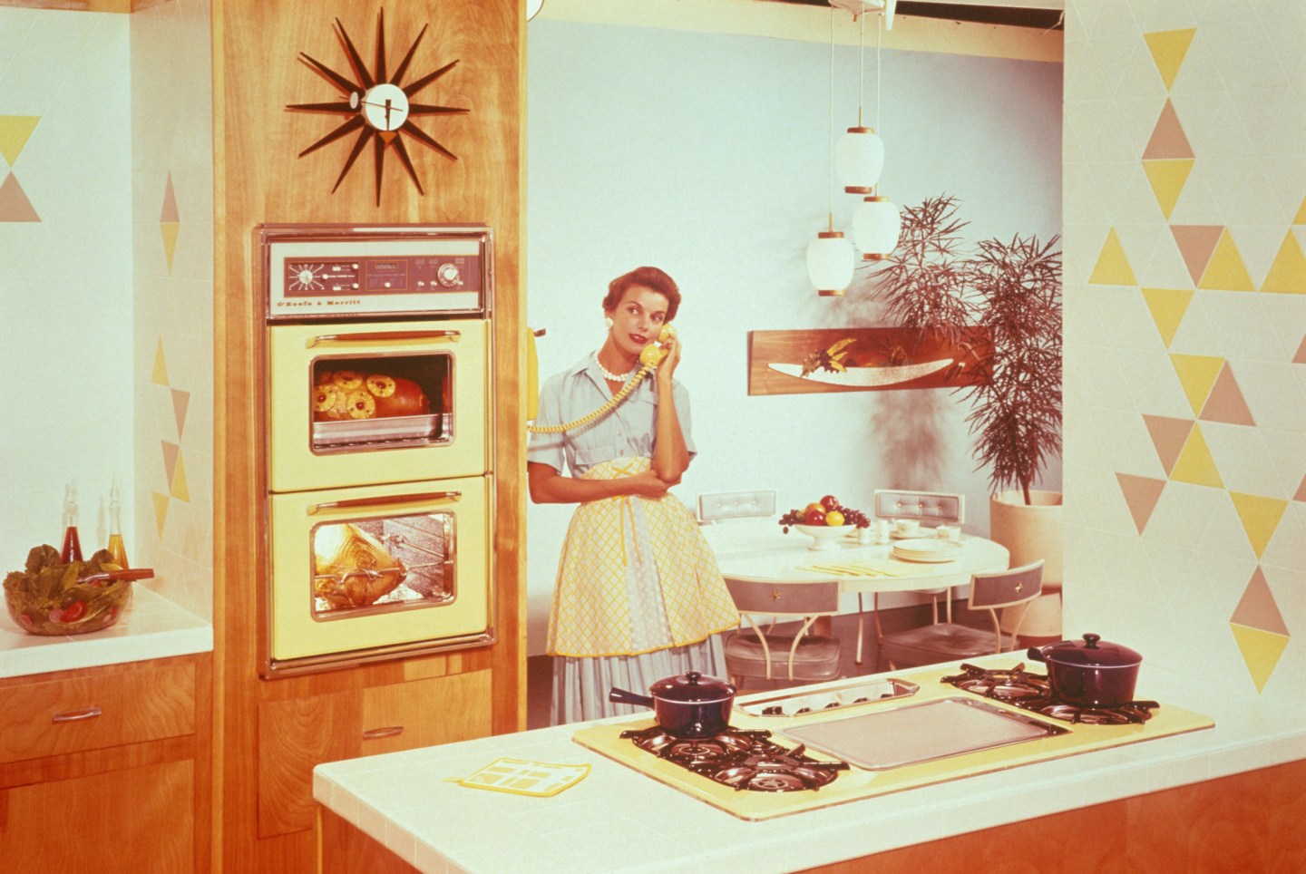 WOMAN SPEAKS ON THE PHONE IN A KITCHEN