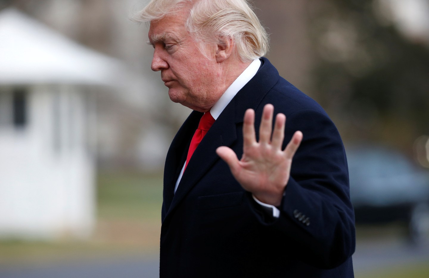 U.S. President Donald Trump waves as he walks from Marine One upon his return to the White House in Washington