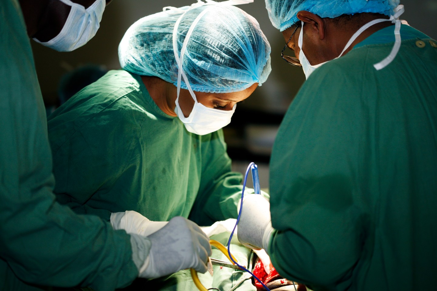 Female surgeon and her assistants operating on patient.