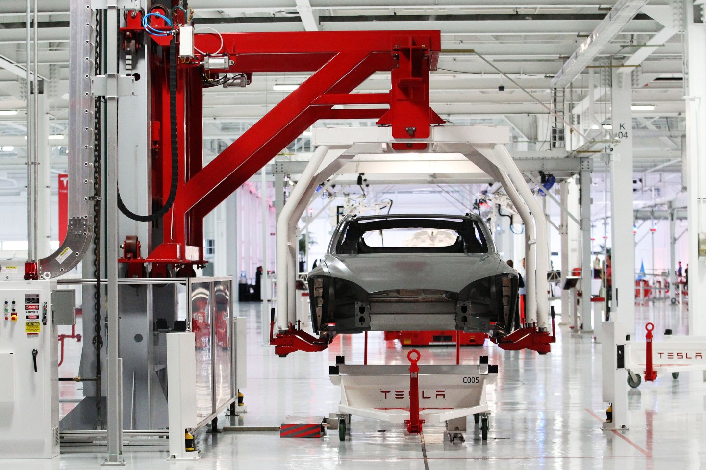 FILE PHOTO -- The body of a Tesla Model S is lifted by an automated crane at the Tesla factory in Fremont