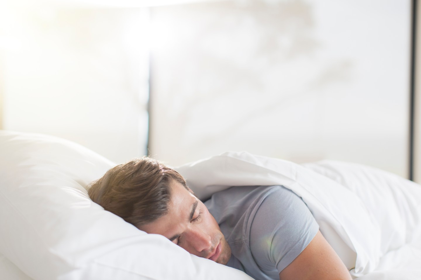 Young man sleeping in bed