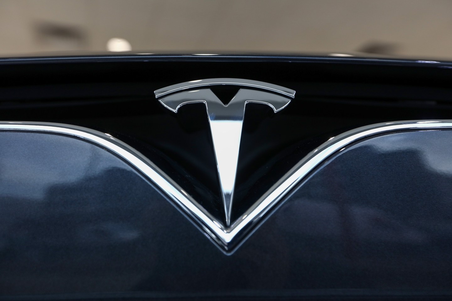 The company badge is displayed on the front of a Tesla Model S car at the company’s showroom in London on Tuesday, Jan. 10, 2017.