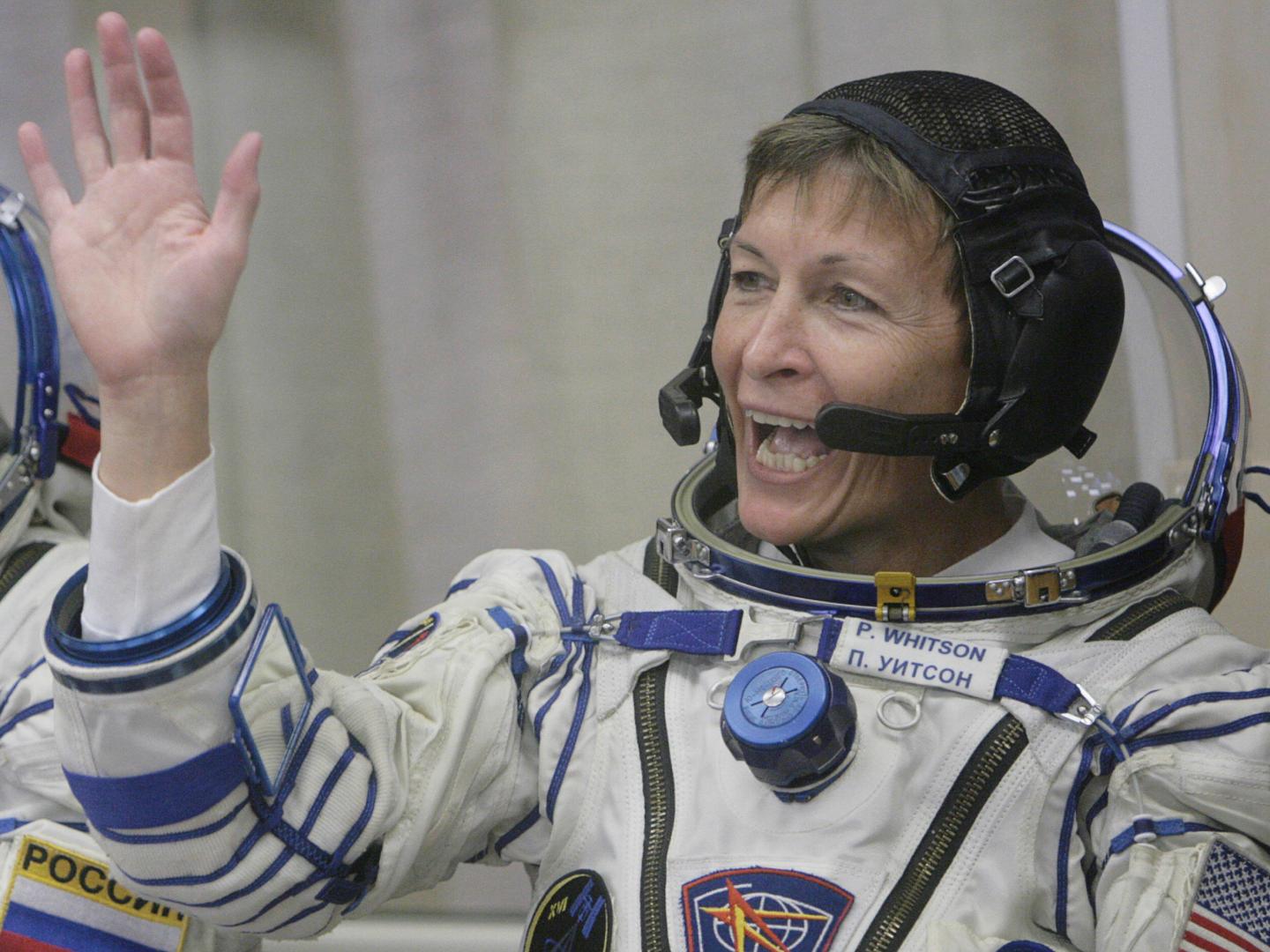 US astronaut Peggy Whitson waves during