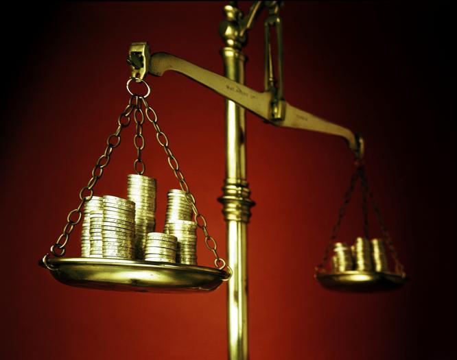 Gold coins being weighed on gold scale