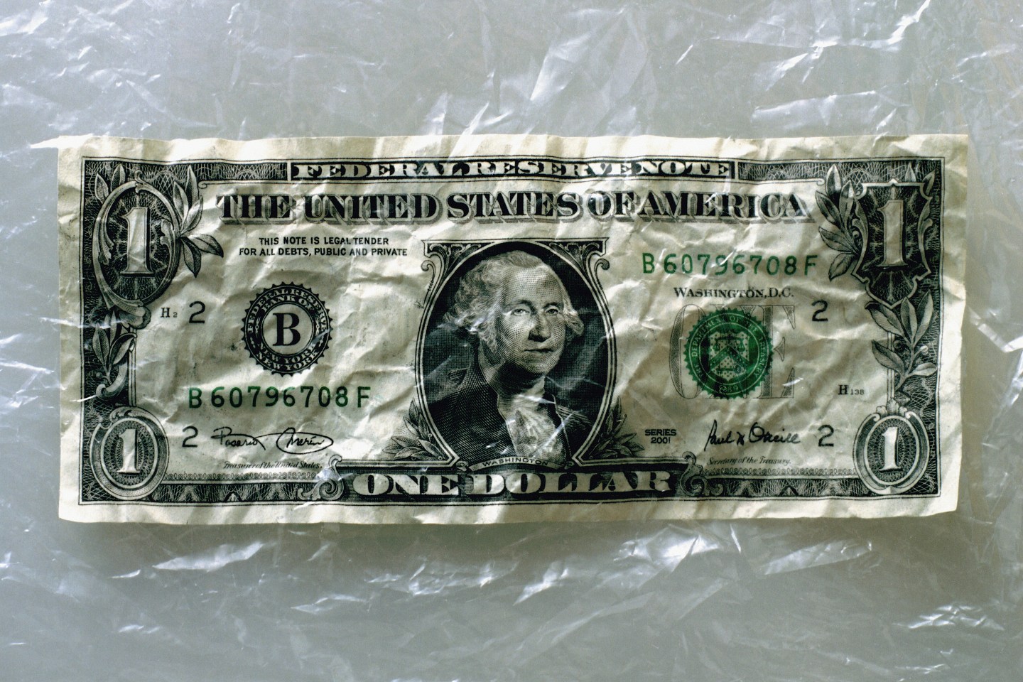 US currency: crumpled one dollar bill
