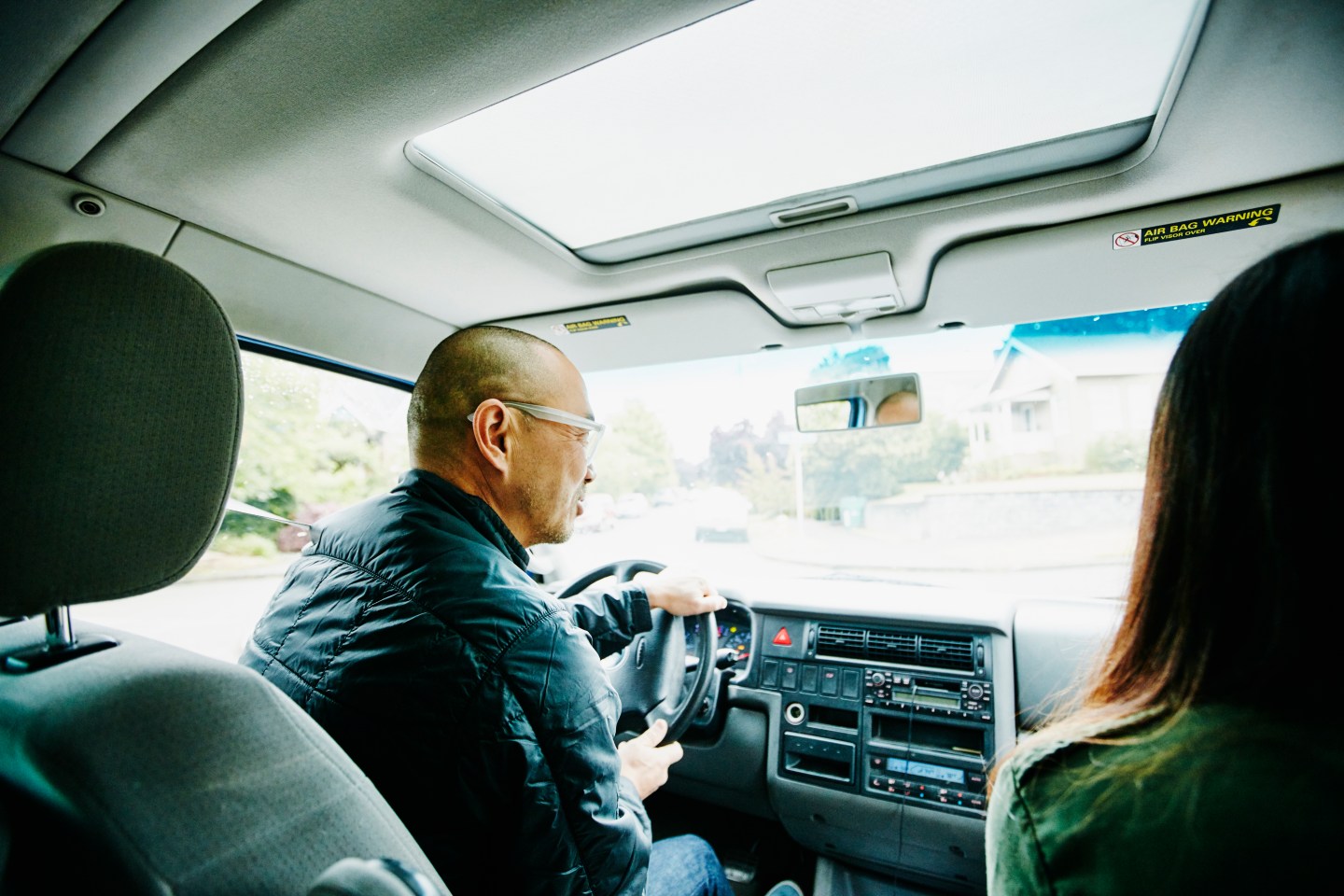 Father in discussion with daughter while driving