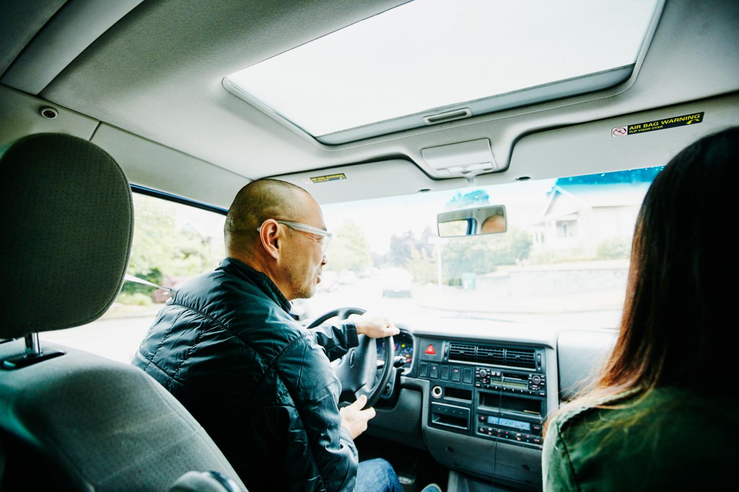 Father in discussion with daughter while driving