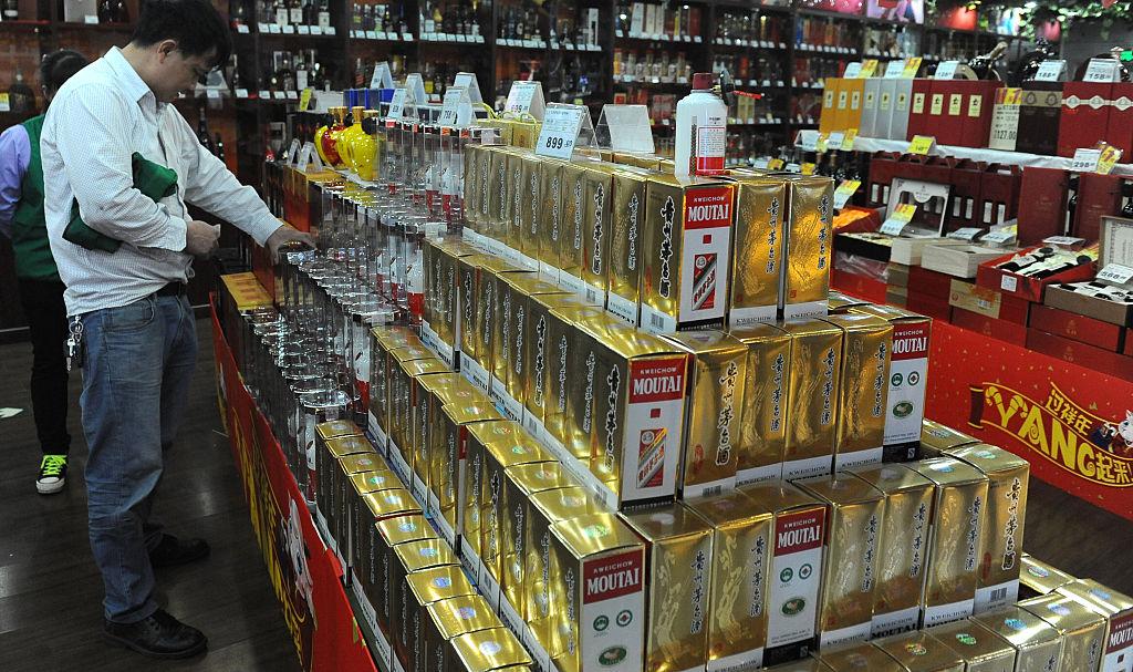 ZHONGSHAN, CHINA - FEBRUARY 09: (CHINA OUT) A customer looks Maotai liquor at a supermarket on February 9, 2015 in Zhongshan, Guangdong Province of China. (Photo by VCG)***_***