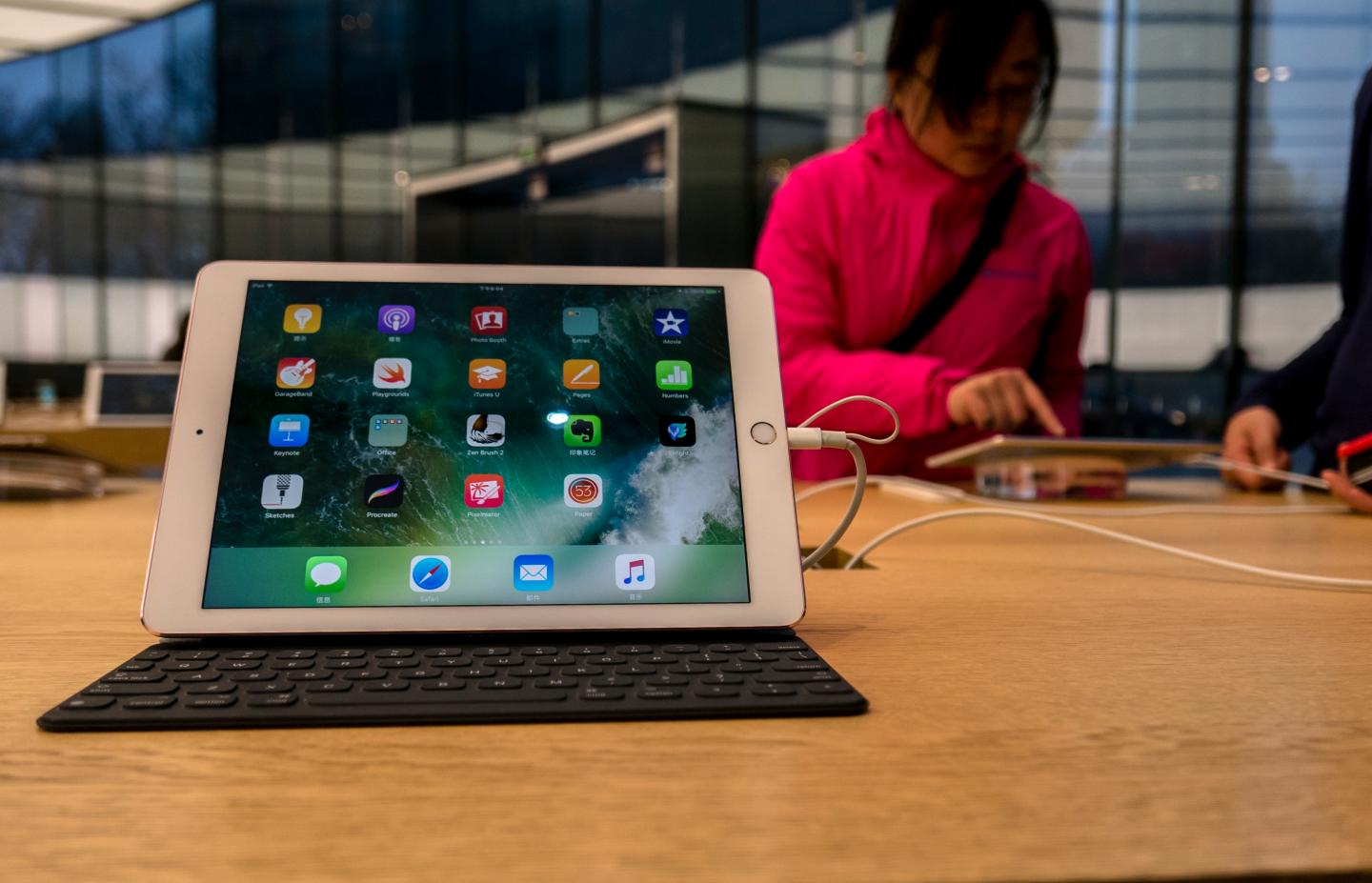 Apps on a iPad shown in an Apple shop.  On the March 25,