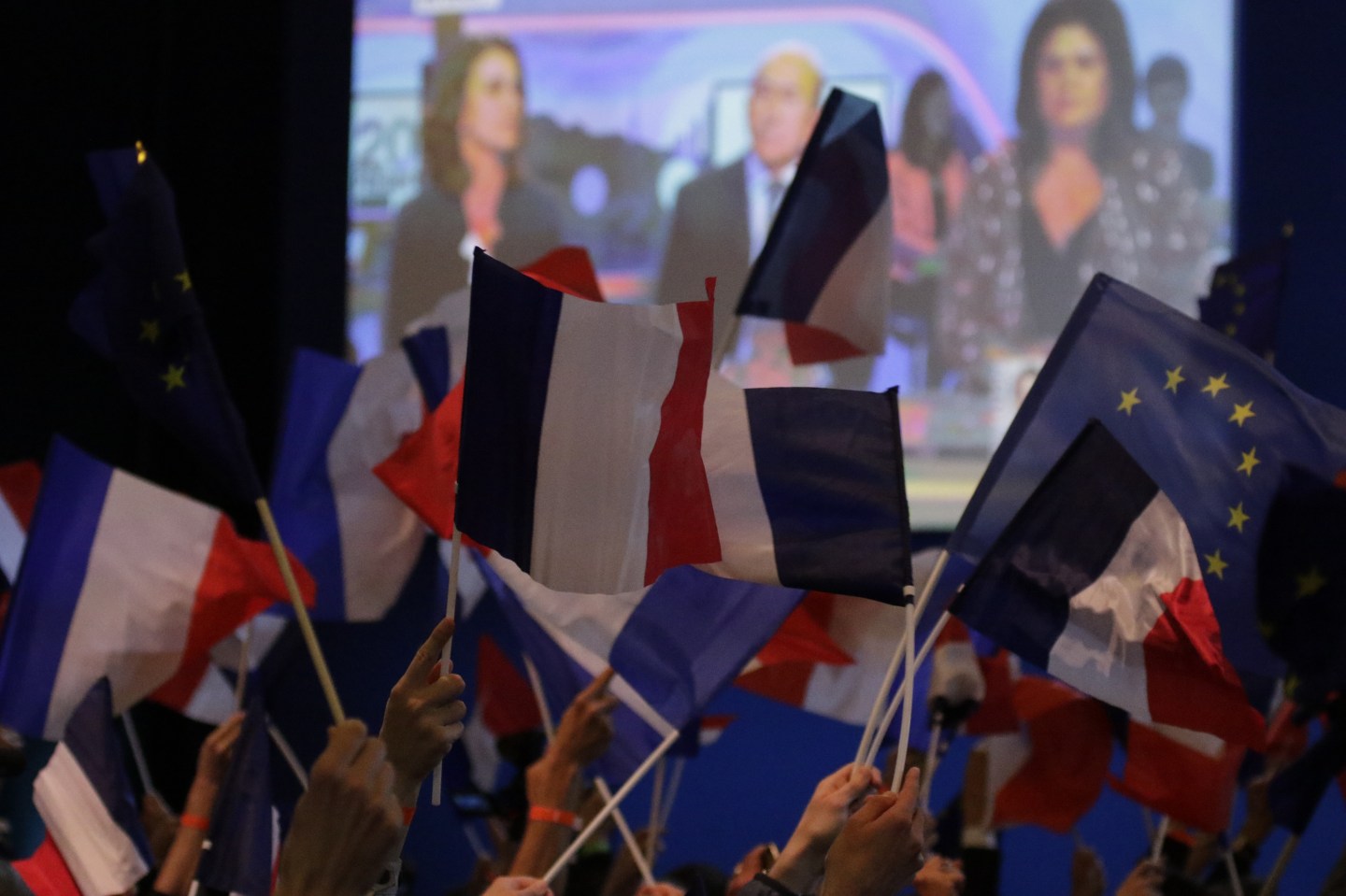 Macron supporters wave French and EU flags after the