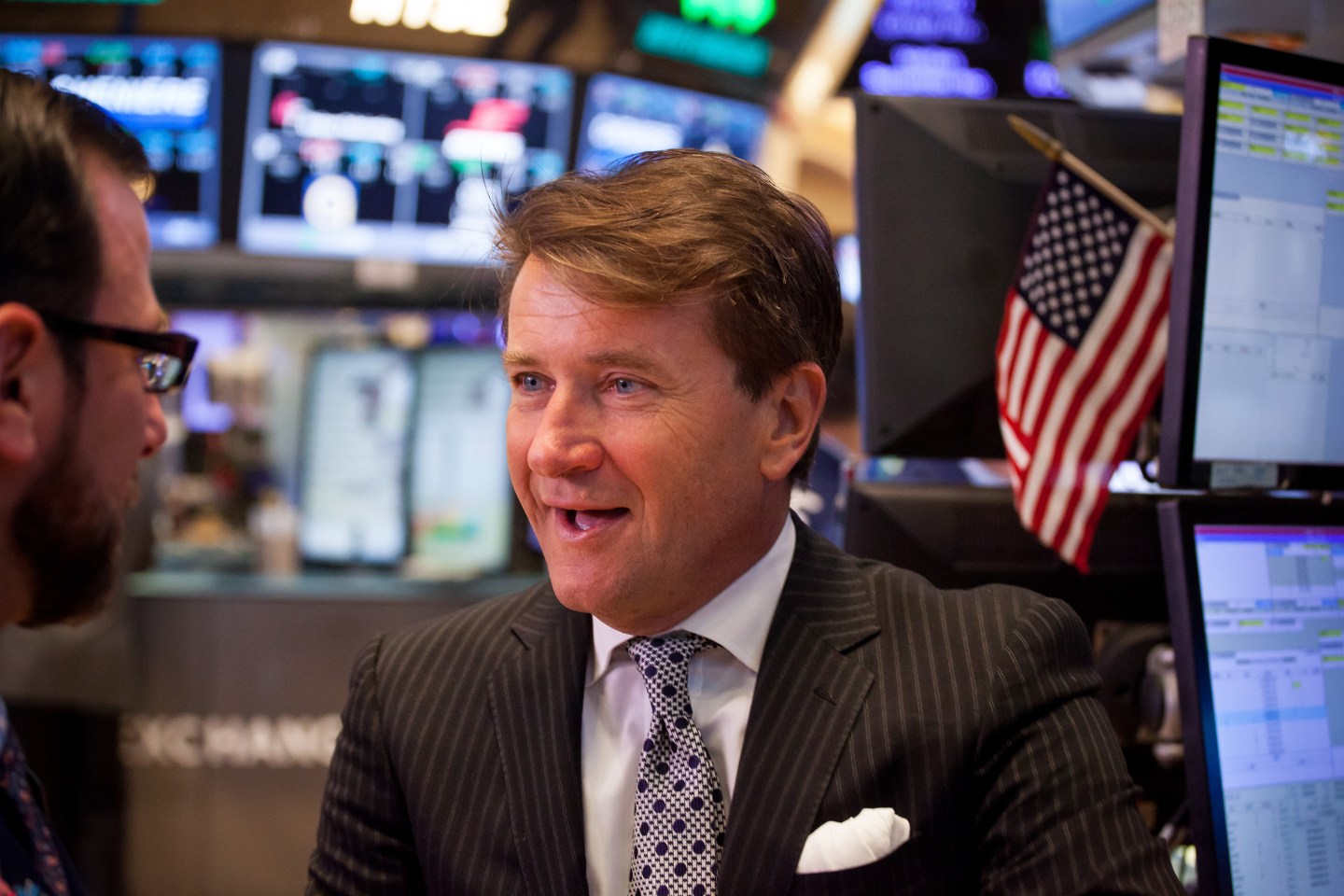 Robert Herjavec, founder and chief executive officer of the Herjavec Group, right, talks with a trader on the floor of the New York Stock Exchange (NYSE) in New York, U.S., on Friday, Jan. 13, 2017.