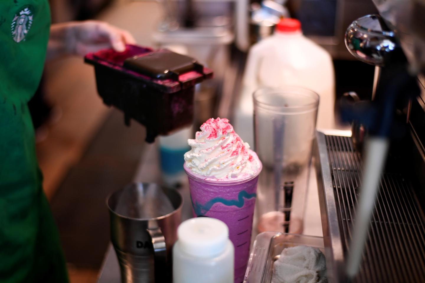 A barista makes a Unicorn Frappuccino beverage at a Starbucks coffeehouse in Austin, Texas