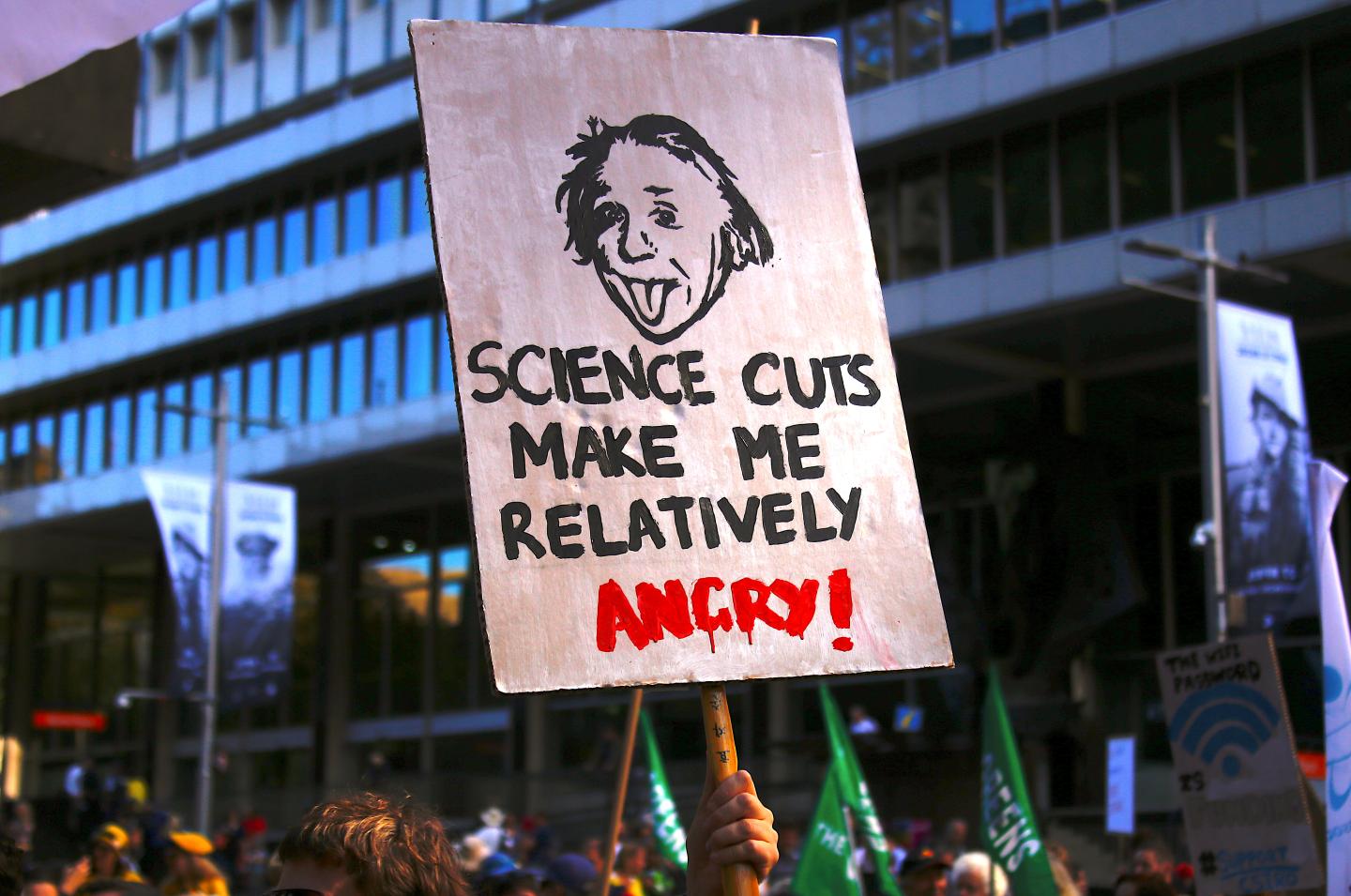 Protesters hold placards and banners as they participate in the March for Science rally on Earth Day, in central Sydney