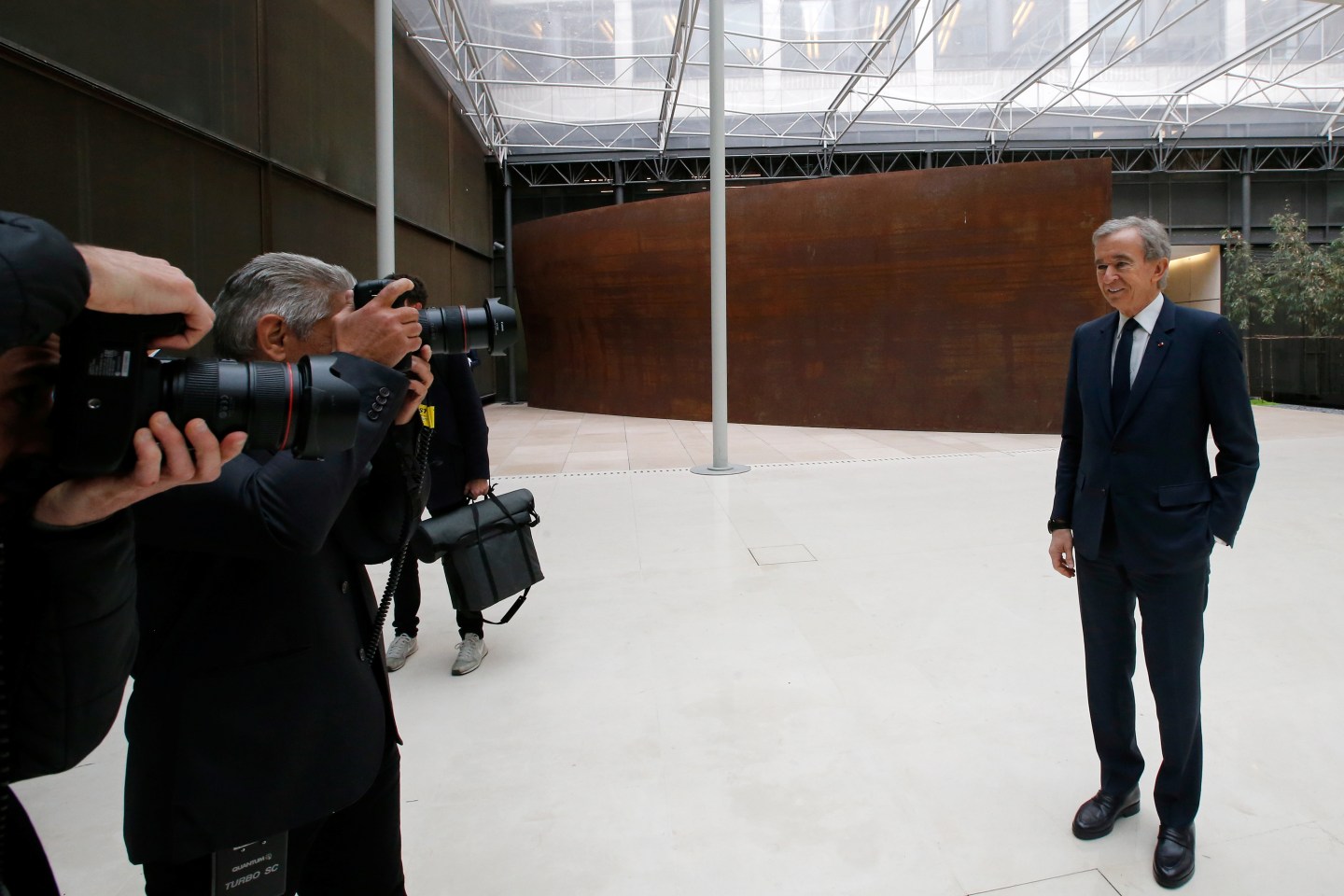 Chairman and CEO of Luxury goods group LVMH Bernard Arnault poses for photographers after a news conference, to announce a deal to simplify Christian Dior business structure, in Paris