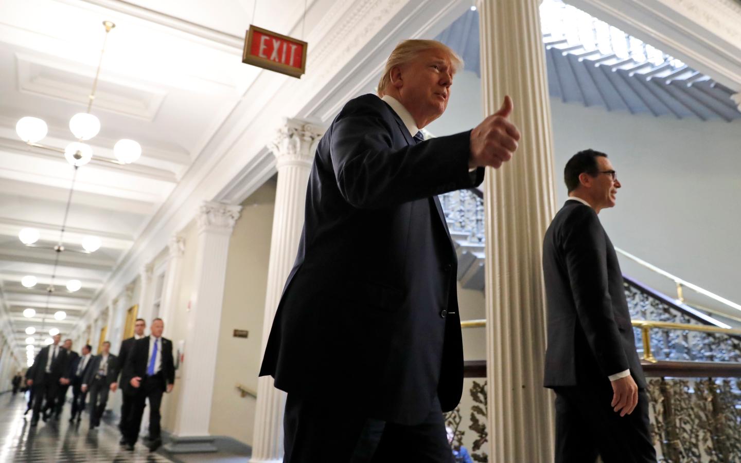 President Donald Trump, accompanied by Treasury Secretary Steve Mnuchin, at the Treasury Department in Washington, Friday, April 21