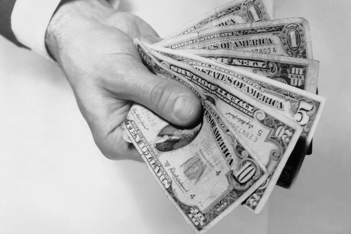 Hand holding out money