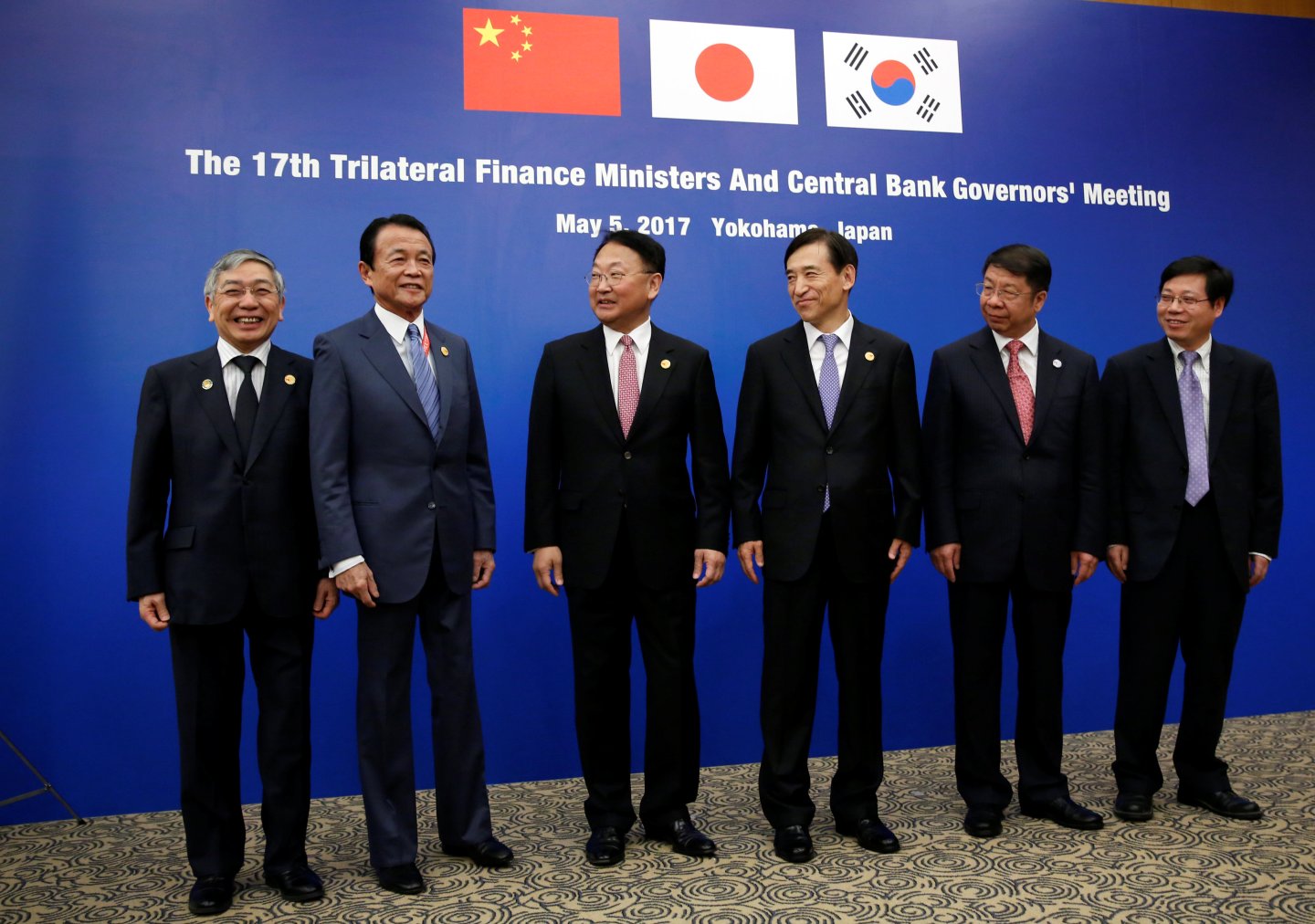 Delegates pose for a photo before their trilateral meeting on the sideline of ADB's annual general meeting in Yokohama