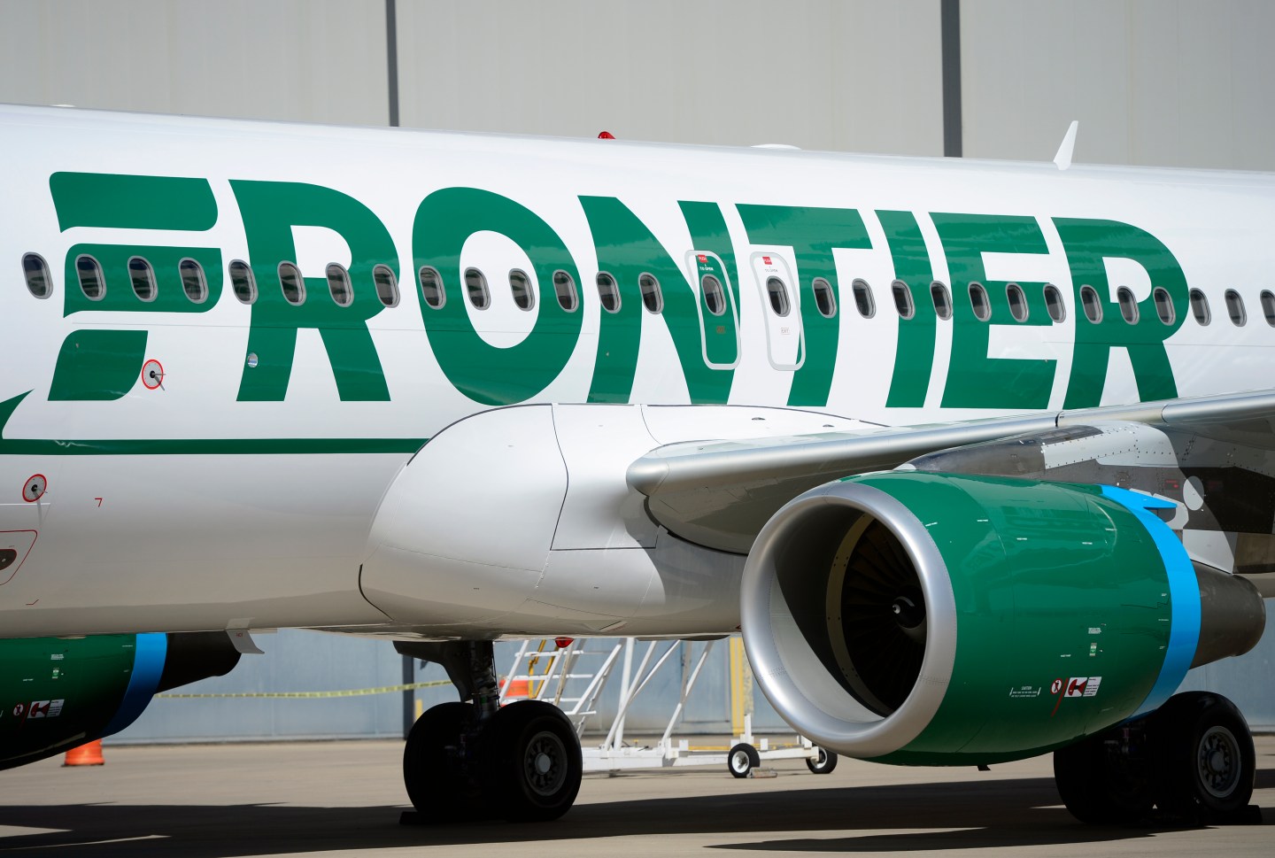 Frontier employees and executives physically pull a 46-ton Airbus A320 out of the Frontier Airlines hanger at Denver International Airport in Denver.