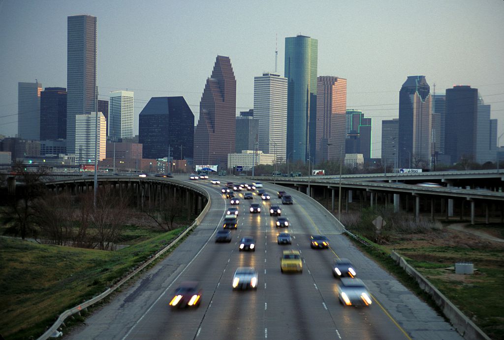 Texas, Houston, Skyline At Dusk And Commuter Traffic