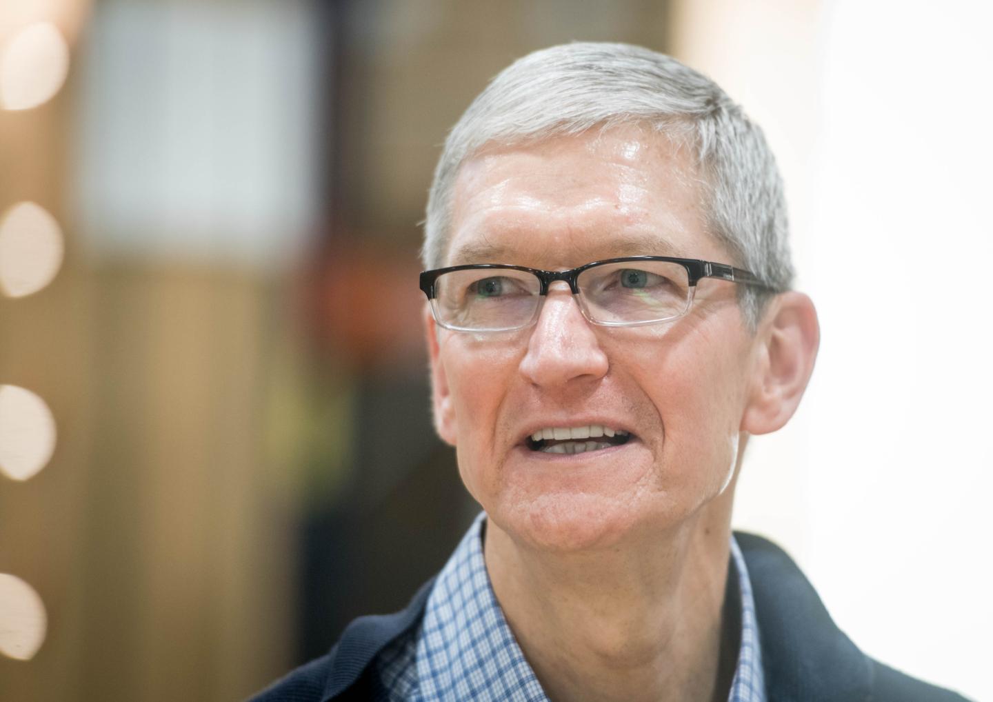 Apple CEO Tim Cook looks on during a visit of the shopfitting company Dula that delivers tables for Apple stores worldwide in Vreden, western Germany, on February 7, 2017.