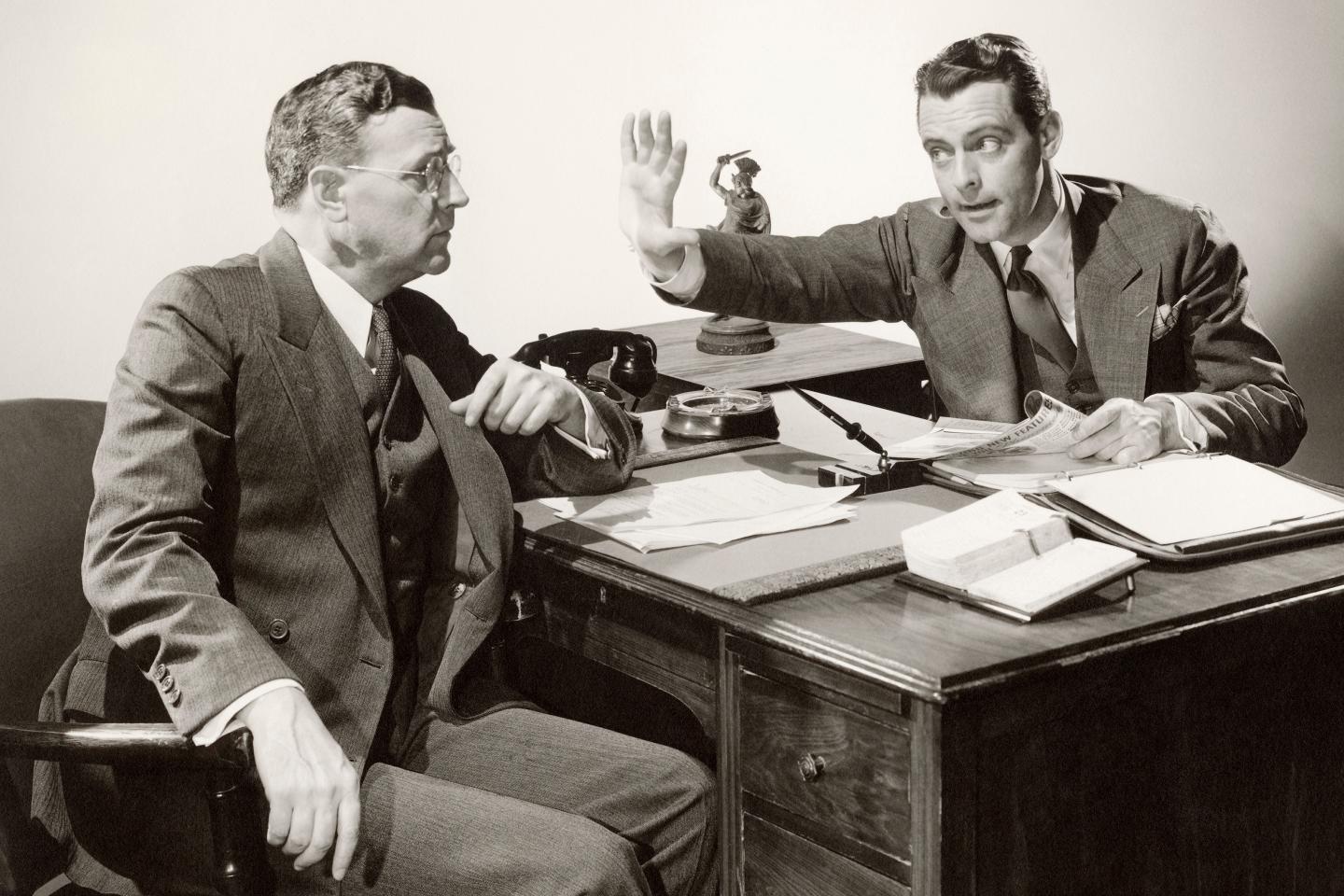 Arguing businessmen at meeting