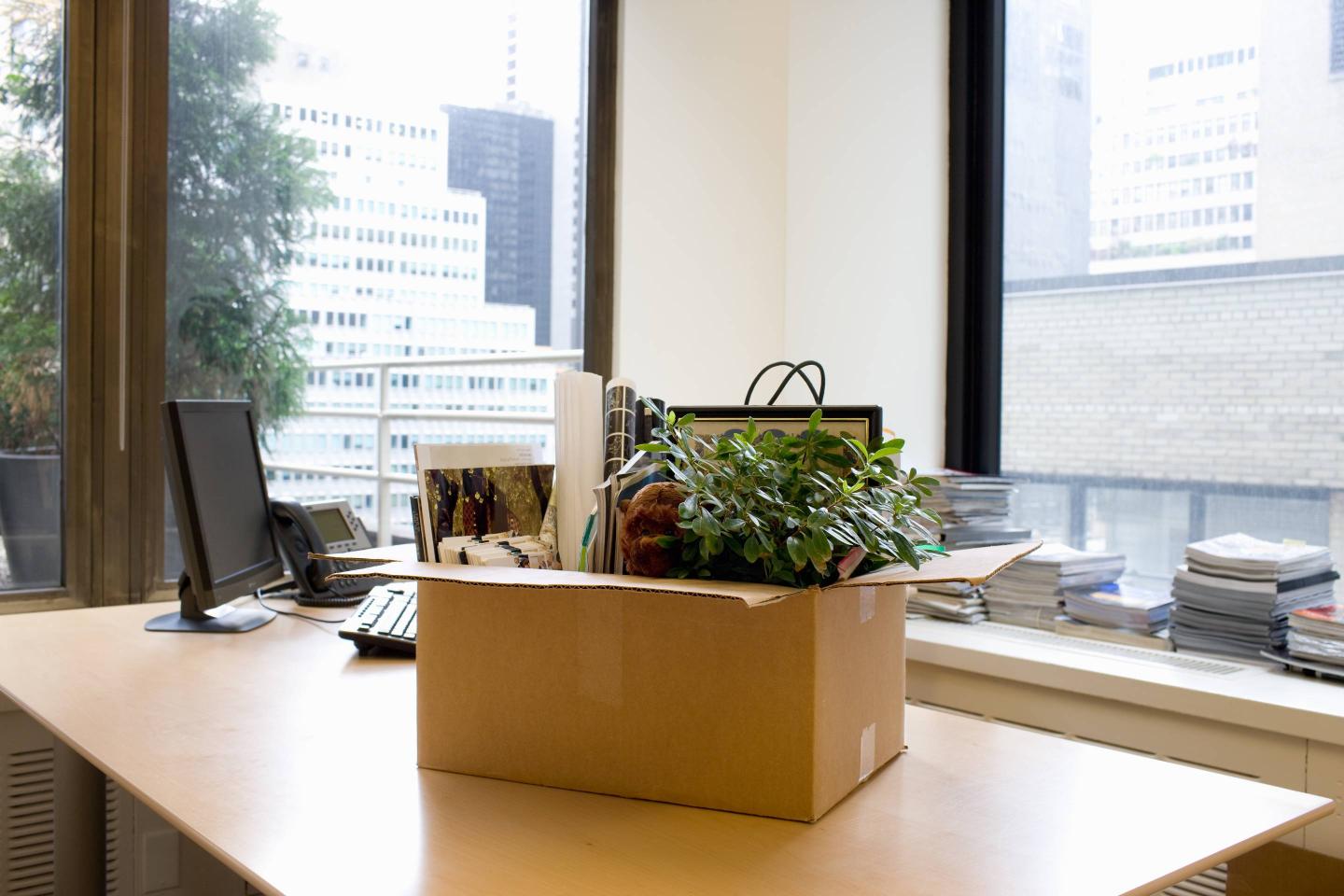 Box of personal items on office desk