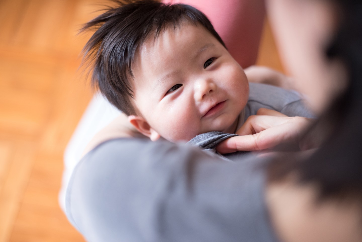 Baby smiling to mother during breastfeeding