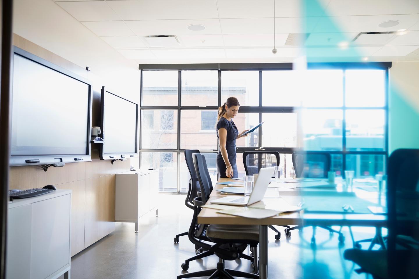 Businesswoman preparing for meeting in conference room