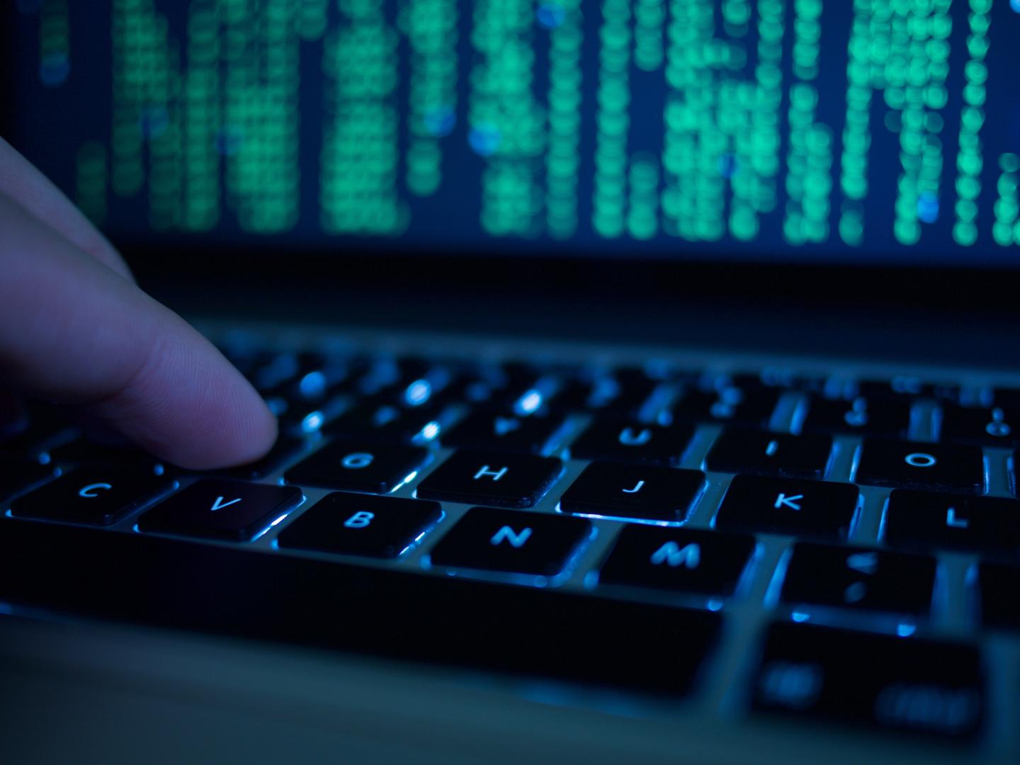 Cropped Hand Of Computer Hacker Typing On Keyboard
