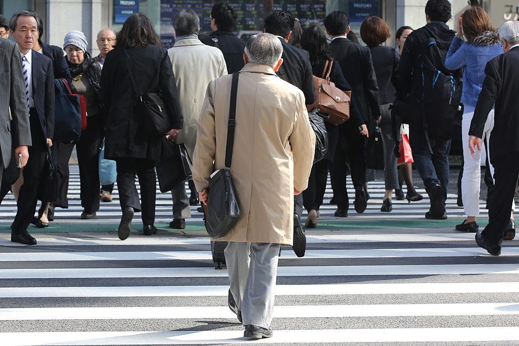 Pedestrians cross a street in Tokyo