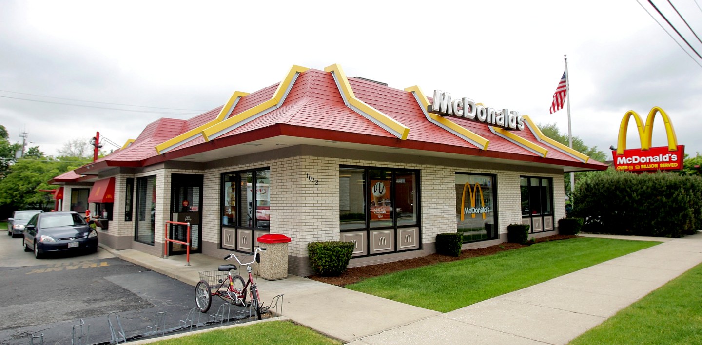 Cars pull up to the drive-through window at a McDonald's res