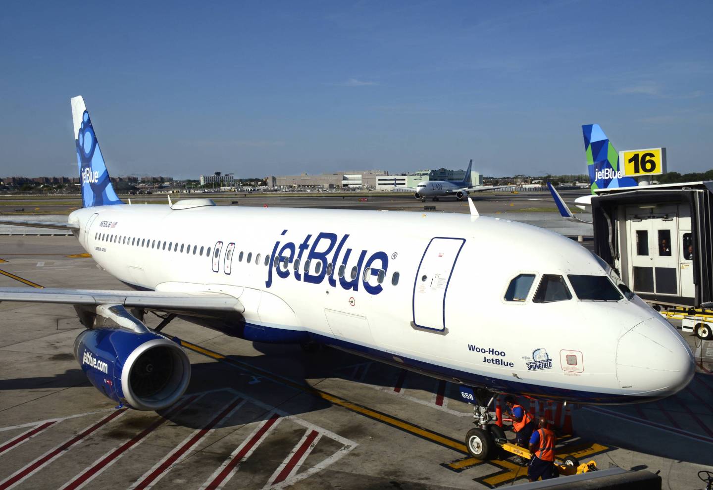 A JetBlue Airways Airbus A320 passenger plane is serviced at a gate at John F. Kennedy International Airport.