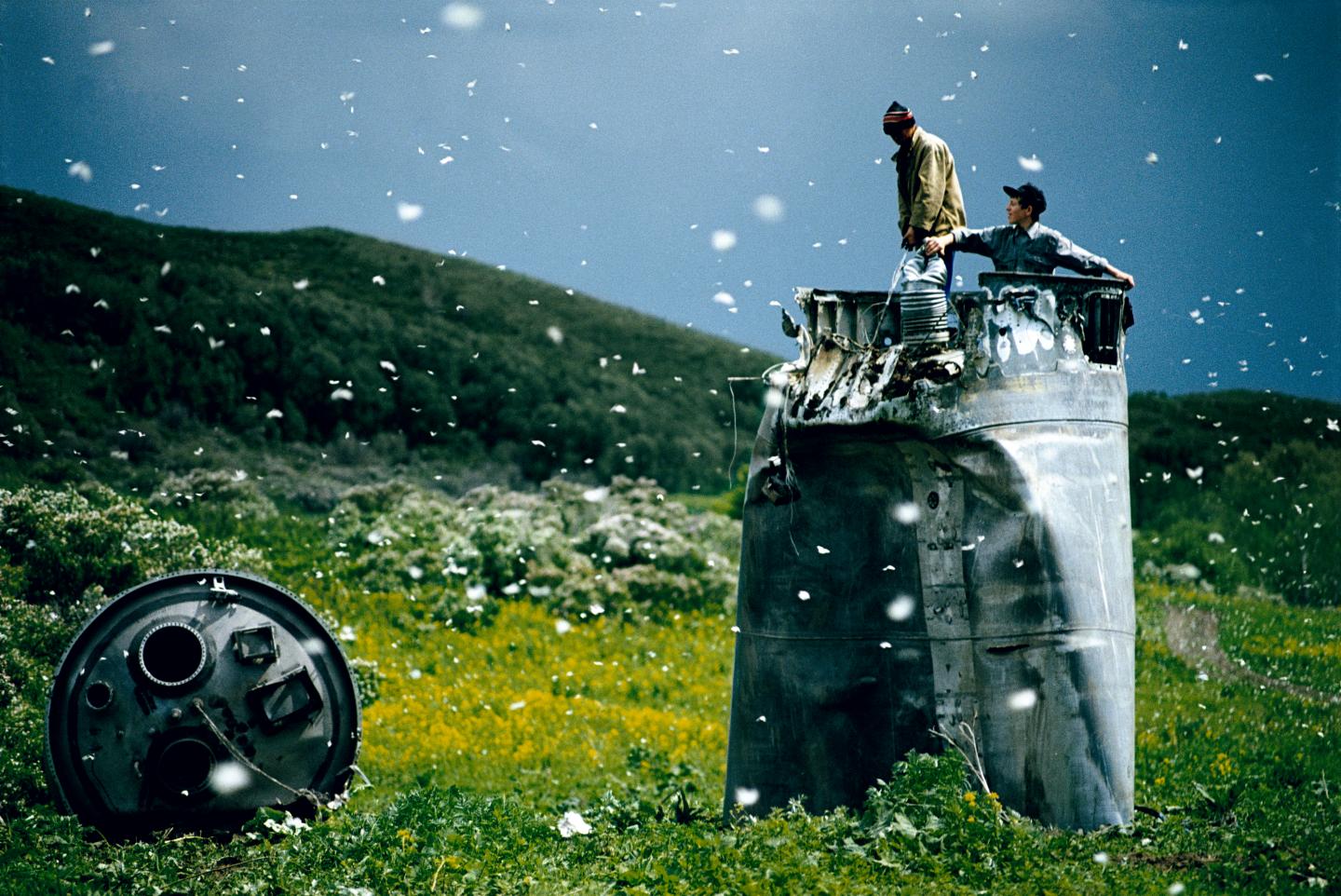 RUSSIA. Altai Territory. 2000. Villagers collecting scrap from a crashed spacecraft, surrounded by thousands of white butterflies.  Environmentalists fear for the region's future due to the toxic rocket fuel.
