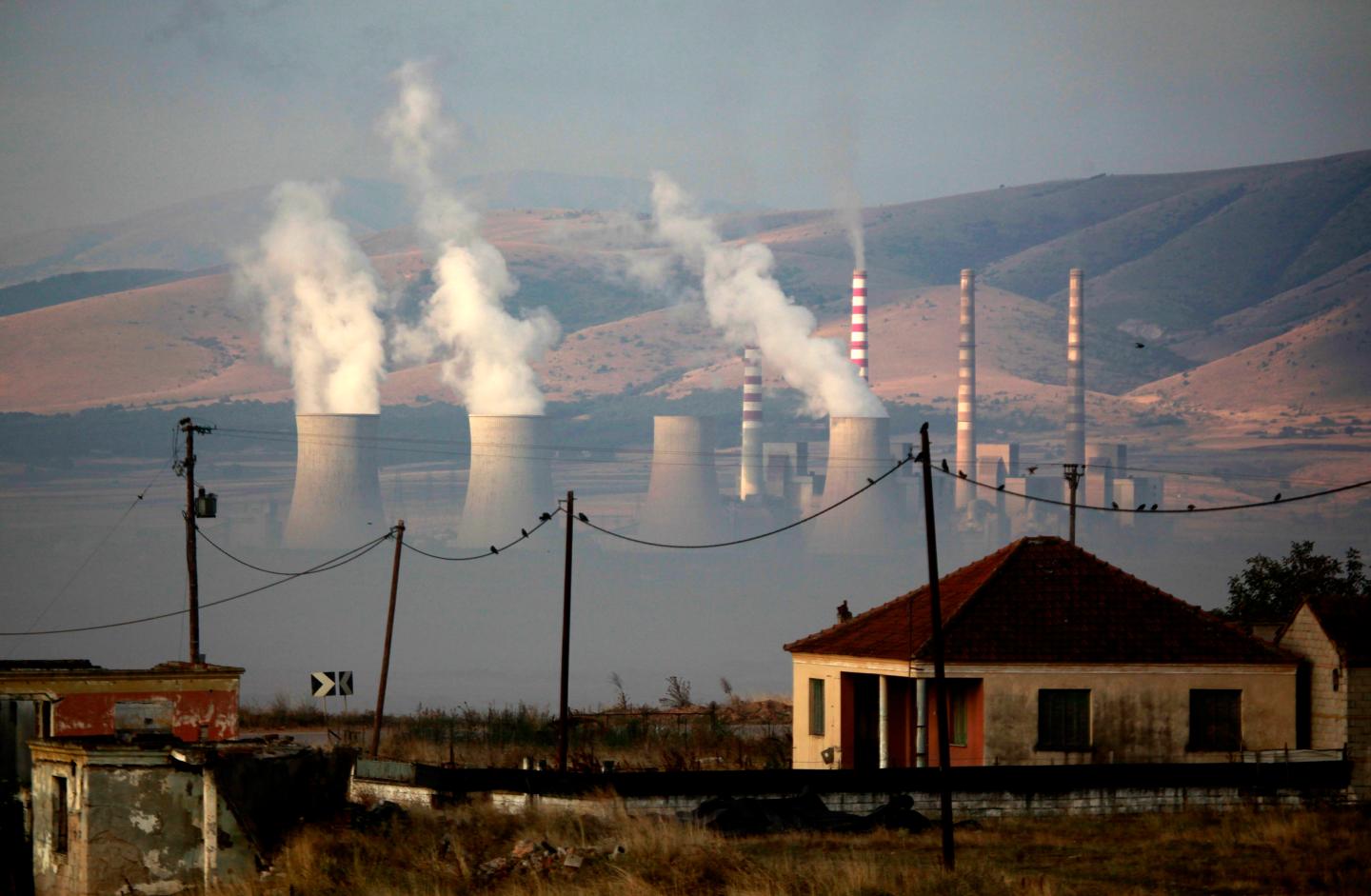 The power plant of Kardia in seen through the once garden of a destroyed house in the village of Charavgi